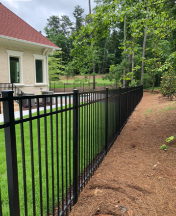 A classic black iron fence separates these Atlanta properties