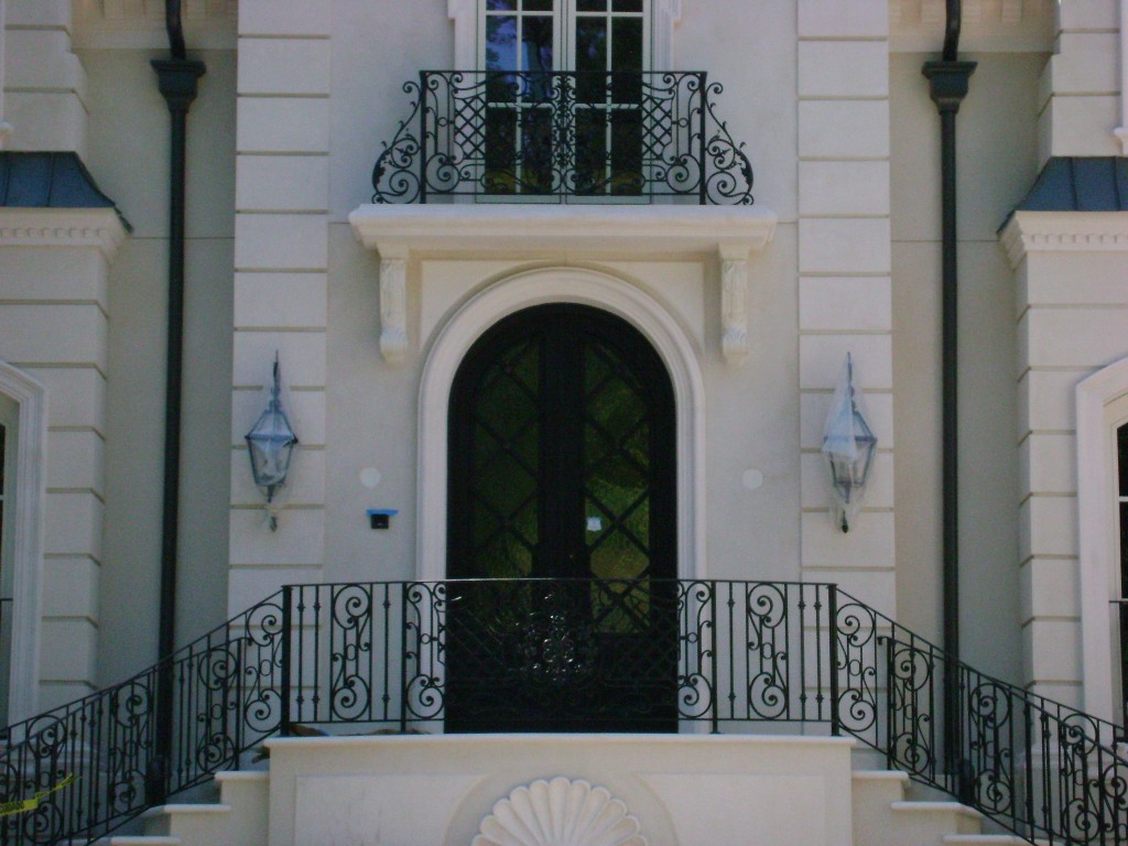 Atlanta home featuring ornate railing on front outdoor steps and balcony