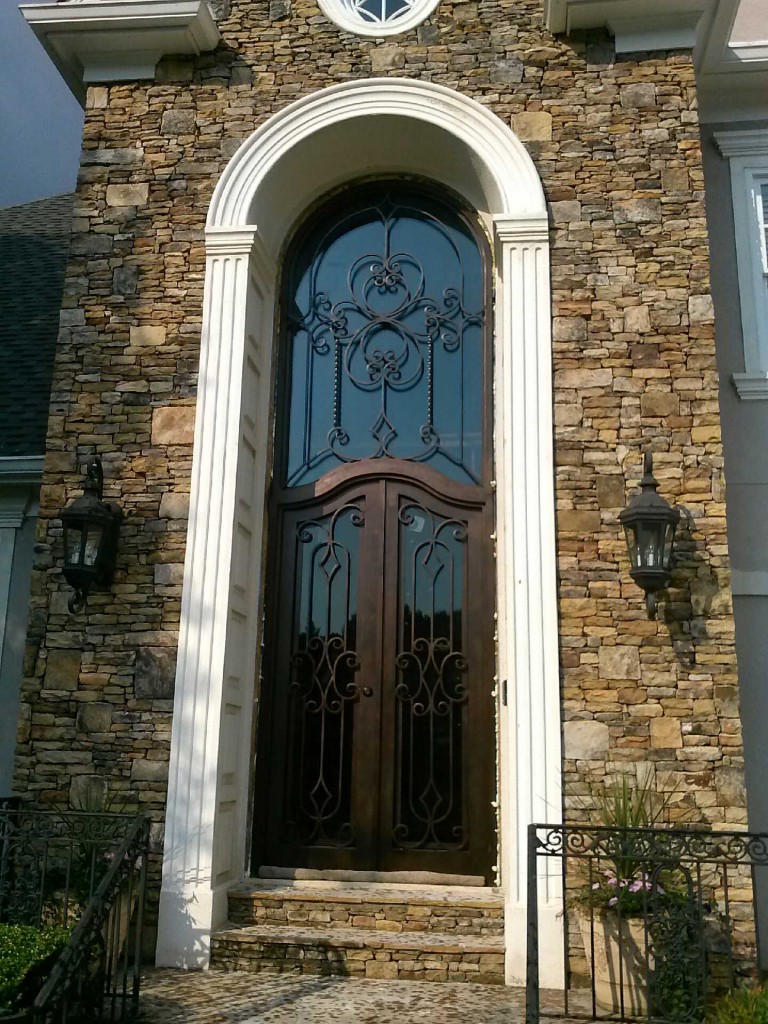 Large tall Atlanta iron door with attached arched transom