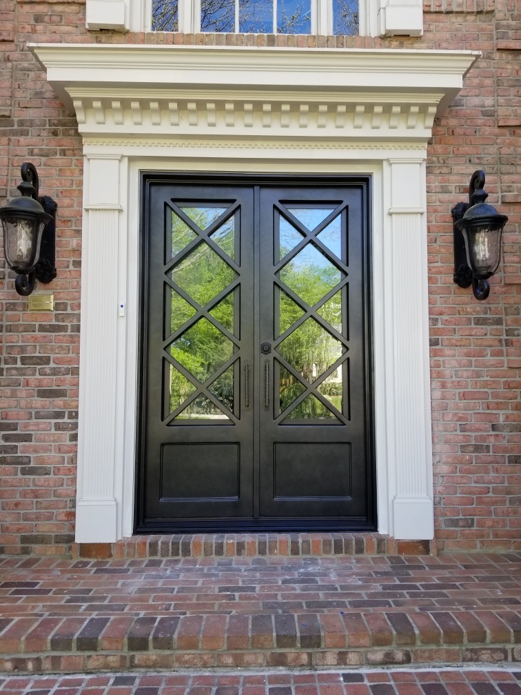 Classic farmstyle custom Atlanta iron door installed on brick home