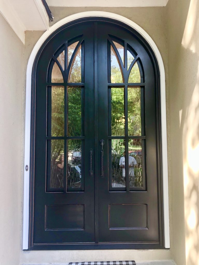 Classic black iron door installed in Atlanta on stucco home